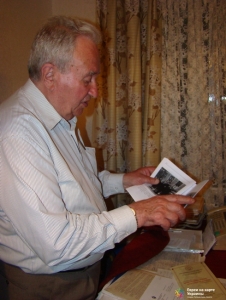 Глава общины Карл Иосифович показывает нам книгу со своей фотографией в военной форме